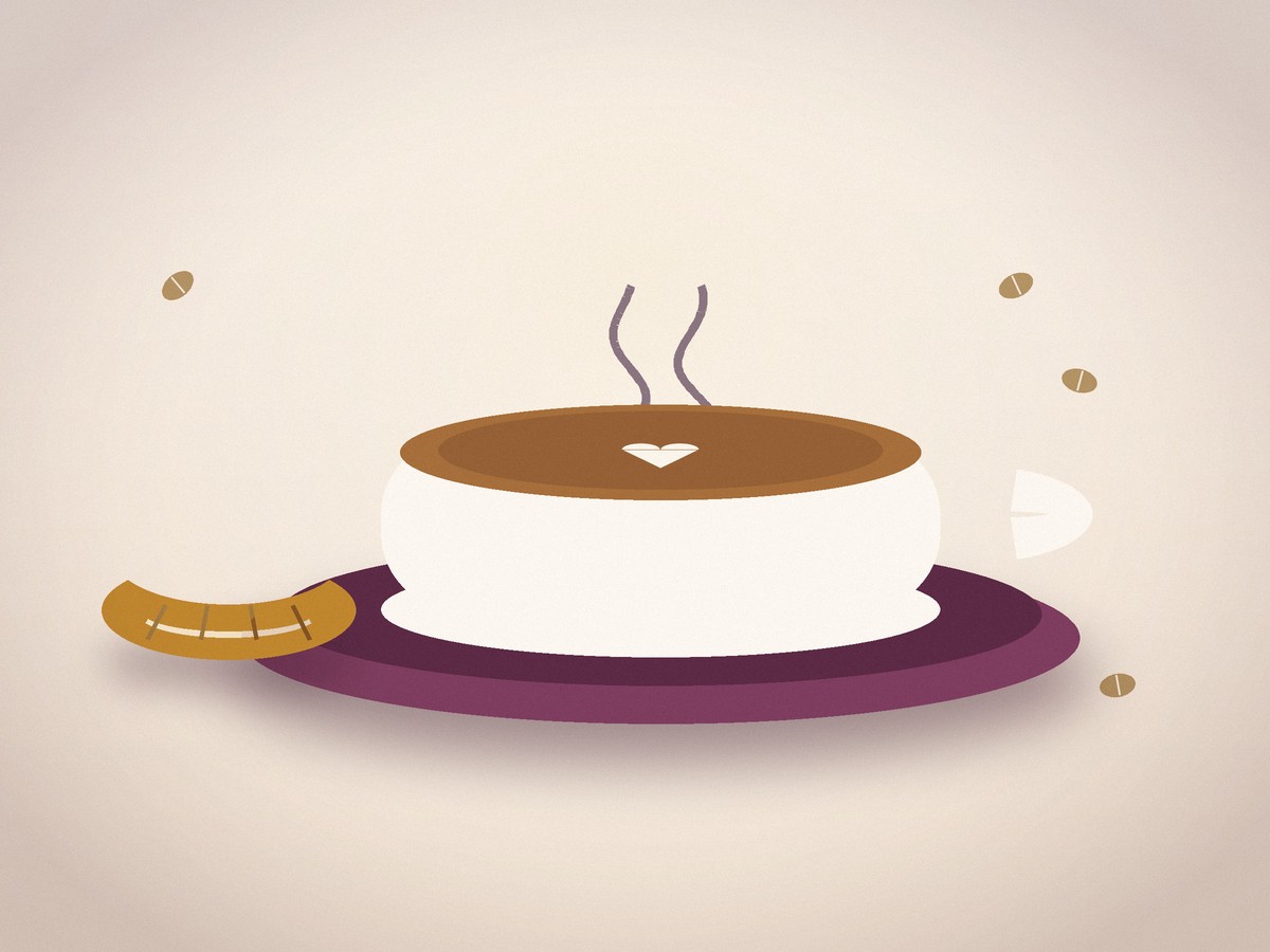 A latte with heart latte art on a saucer beside a small pastry